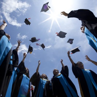 Students,Throwing,Graduation,Hats,In,The,Air,Celebrating Students,Throwing,Graduation,Hats,In,The,Air,Celebrating
